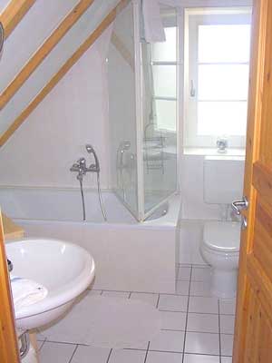 Badezimmer der Ferienwohnung mit Wanne und Duschm&ouml;glichkeit. Fenster zur Bel&uuml;ftung.